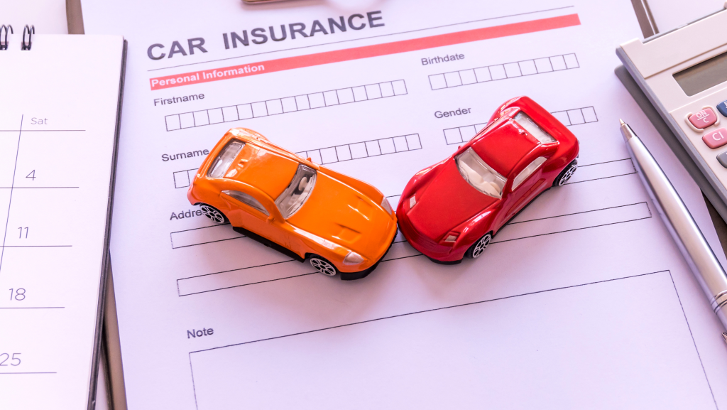 Car insurance coverage form with vehicles and calculator nearby.