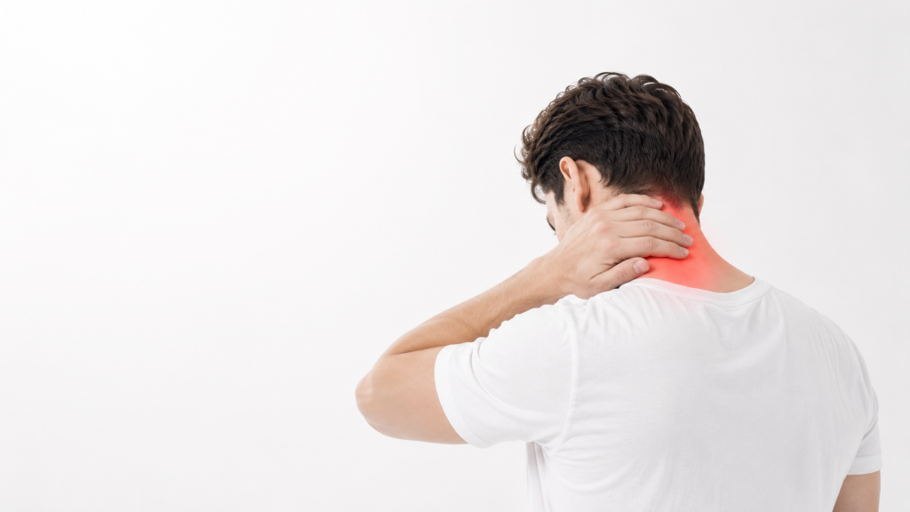 Person holding the back of their neck after a Georgia car accident, illustrating whiplash and neck pain symptoms.